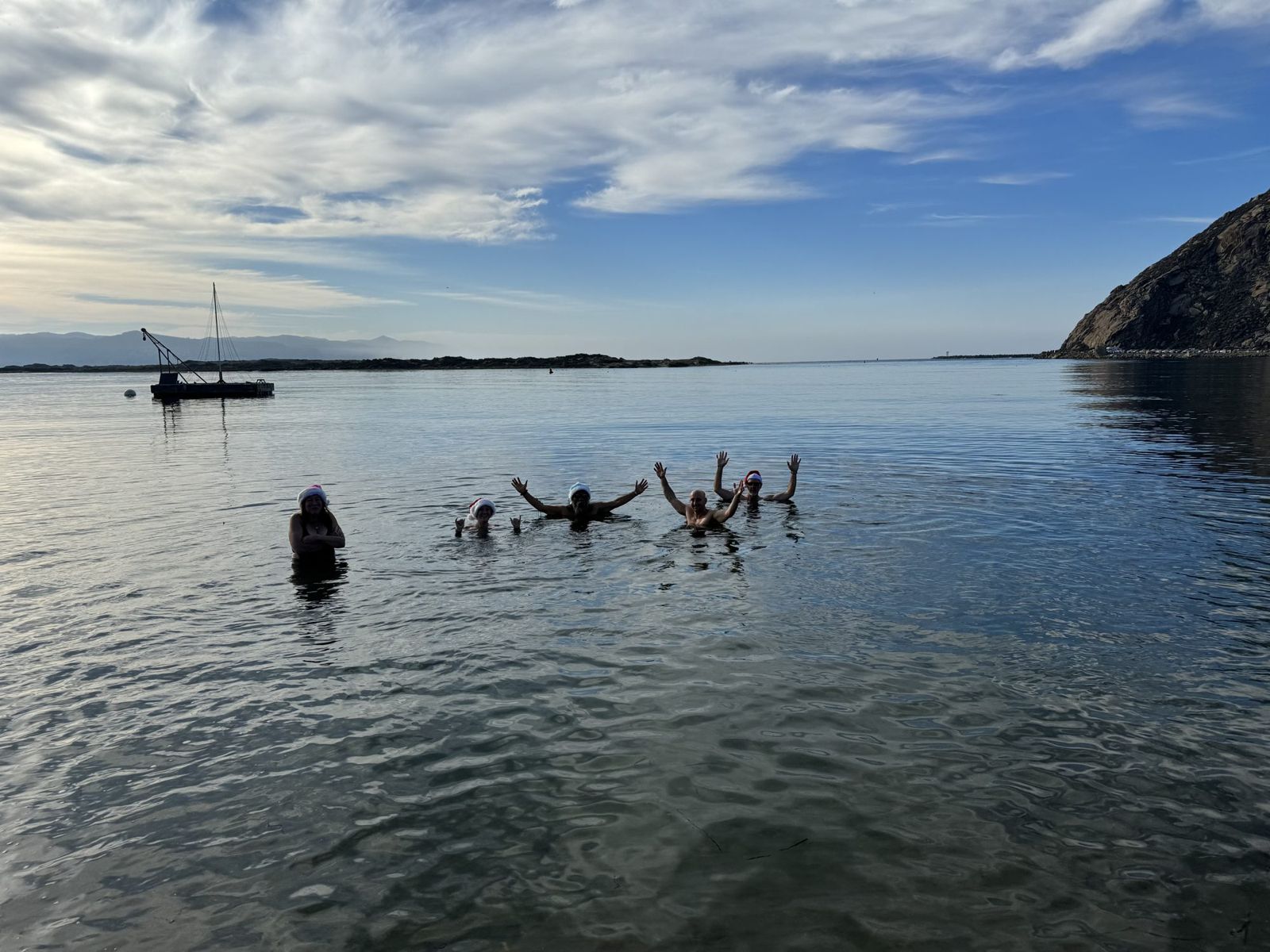 Odders throwing their arms up in the open bay on a bright morning